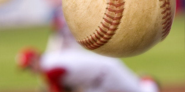 A baseball player pitching with spin on the ball. (motion blur on ball)