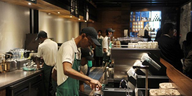 Baristas work behind the counter at the newly-inaugurated Starbucks outlet in New Delhi on February 6, 2013. Starbucks, the world's biggest coffee chain, launched its first outlet in New Delhi on Wednesday with an aim to expand its reach to customers across India. AFP PHOTO/ SAJJAD HUSSAIN (Photo credit should read SAJJAD HUSSAIN/AFP/Getty Images)