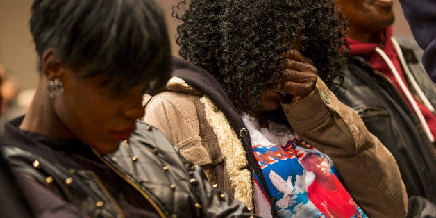 Gloria Darden, mother of Freddie Gray, covers her face during a news conference after a day of unrest following the funeral of Gray on Monday, April 27, 2015, in Baltimore. Rioters plunged part of Baltimore into chaos torching a pharmacy, setting police cars ablaze and throwing bricks at officers. (AP Photo/Evan Vucci)