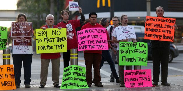 MIAMI, FL - MARCH 20: Union members and community activists protest outside the Miami Dade College where the Greater Miami Chamber of Commerce and the college were hosting a moderated conversation with U.S. Secretary of the Treasury Jacob Lew on March 20, 2015 in Miami, Florida. The protesters are against the Trans-Pacific Partnership (TPP) which is a proposed twelve-nation pact and are asking the Federal Government and Florida Congressional delegation to reject fast tracking the TPP and warn that the deal poses serious risk to jobs and wages, the environment, food safety and public health for Floridas working families. (Photo by Joe Raedle/Getty Images)