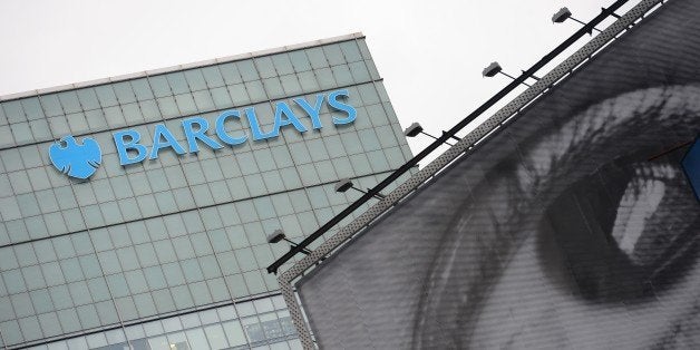 Barclays' bank logo is seen above a billboard displaying art photography in New York, June 11, 2013. AFP PHOTO/Emmanuel Dunan