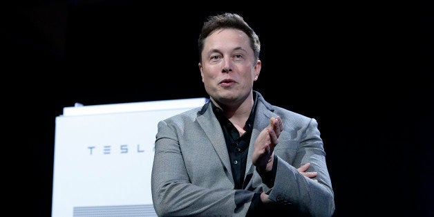 LOS ANGELES, CA - APRIL 30: Elon Musk, CEO of Tesla, with a Powerpack unit the background unveils suit of batteries for home