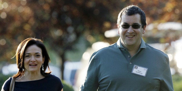 FILE - In this July 10, 2013 file photo, Sheryl Sandberg, COO of Facebook, left, and her husband David Goldberg, CEO of Surve