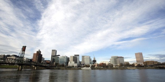 The Portland skyline is visible on the bank of the Willamette River in Portland, Ore., Wednesday, Dec. 3, 2014. The White Ho