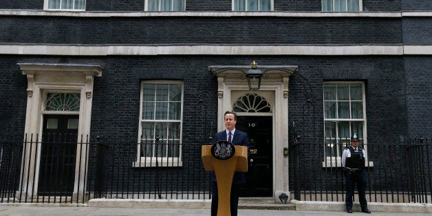 Britain's Prime Minister David Cameron speaks to the media outside 10 Downing Street in London Friday, May 8, 2015. Cameron's Conservative Party swept to power Friday in Britain's Parliamentary General Elections, winning an unexpected majority. (AP Photo/Kirsty Wigglesworth)