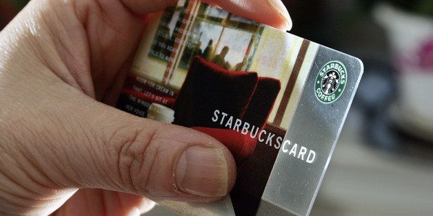 A person holds a Starbucks Coffee card Wednesday, Nov. 31, 2007 in Pennington, N.J. Starbucks Corp. releases first-quarter earnings after the bell. (AP Photo/Mel Evans)