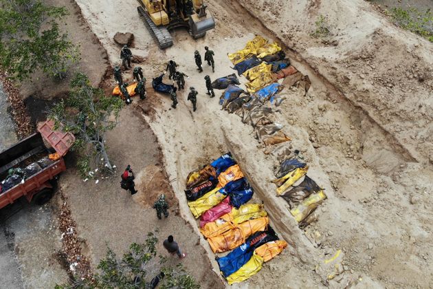 Indonesian soldiers burying quake victims in a mass grave in Poboya in Indonesia's Central Sulawesi on 2 October.