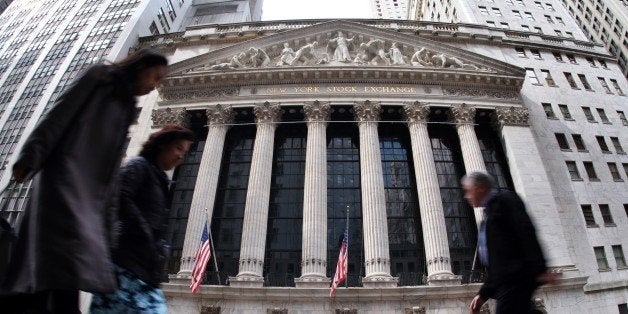 People walk past the New York Stock Exchange (NYSE) building on March 11, 2015 in New York. The average Wall Street bonus rose two percent in 2014 as hiring in New York City's financial sector picked up, according to a government report released on March 11, 2015. AFP PHOTO/JEWEL SAMAD (Photo credit should read JEWEL SAMAD/AFP/Getty Images)