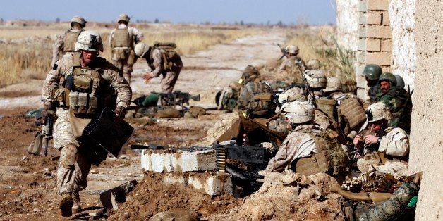 A Marine with Weapons Platoon, Charlie Company, 1st Battalion, 3rd Marine Regiment, sprints down the line of heavy machine gu