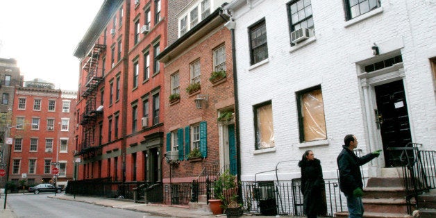 Passersby look at 14 Gay Street, (building at right,) in New York's Greenwich Village neighborhood, Thursday, Dec. 25, 2003. An extension cord ignited a fatal fire that ripped through the basement apartment of the historic Manhattan apartment building early Thursday. The apartment, at 14 Gay Street, was once home to Ruth McKenney, whose writings inspired the 1953 musical ``Wonderful Town.'' A revival of the show, about a pair of sisters who move to Greenwich Village from Ohio to follow their dreams, iscurrently running on Broadway. (AP Photo/Tina Fineberg)