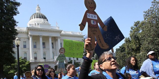 In this photo taken Wednesday May 6, 2015, hundreds calling for more funding for child care programs rallied at the Capitol in Sacramento, Calif. Gov. Jerry Brown will unveil his revised state budget this week as Democrats jockey to spend some of the growing $3 billion surplus on child care, higher education and other social programs.(AP Photo/Rich Pedroncelli)