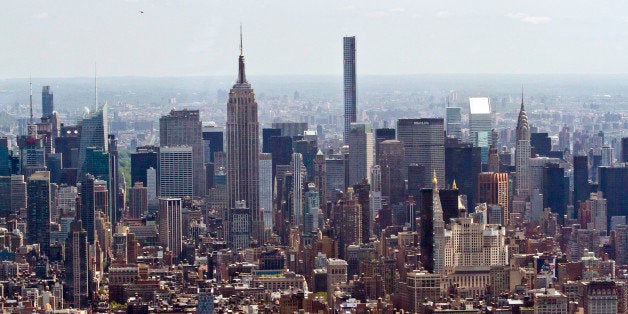 A view from One World Observatory shows The Empire State building and parts of Manhattan after a ribbon-cutting ceremony, Friday, May 29, 2015, in New York. The World Trade Center observatory officially opened to the public giving visitors a view of the city and its surroundings from above 1,250 feet, with sight lines stretching 50 miles past the Manhattan skyline. (AP Photo/Bebeto Matthews)