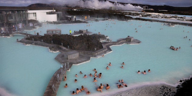 REYKJAVIK, ICELAND - APRIL 07: Visitors sit in the geothermal waters at the Blue Lagoon close to the Icelandic capital of Reykjavik on April 7, 2014 in Reykjavik, Iceland. Since the financial meltdown of 2008 which saw the Icelandic economy come close to collapse the island has been slowly recovering and unemployment levels are beginning to return to normal. (Photo by Matt Cardy/Getty Images)