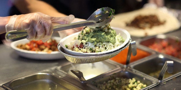 MIAMI, FL - APRIL 27: Chipotle restaurant workers fill orders for customers on the day that the company announced it will only use non-GMO ingredients in its food on April 27, 2015 in Miami, Florida. The company announced, that the Denver-based chain would not use the GMO's, which is an organism whose genome has been altered via genetic engineering in the food served at Chipotle Mexican Grills. (Photo by Joe Raedle/Getty Images)