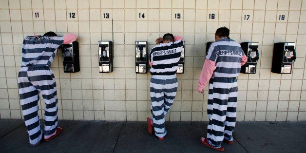 Inmates talk on pay phones in Maricopa County Sheriff Joe Arpaio's jail in Phoenix on Thursday, Jan. 31, 2008. The Tent City Jail is one of Arpaio's most acclaimed and notorious creations. With Super Bowl XLII being played Sunday, Feb. 3, in nearby Glendale, Ariz., one certainly gets the impression that Arpaio wouldn't mind locking up someone famous before the week is out. (AP Photo/Charlie Riedel)