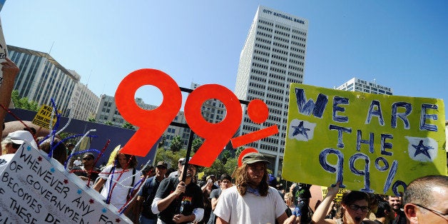 LOS ANGELES, CA - OCTOBER 01: Protesters hold signs as they march to Los Angeles City Hall during the 'Occupy Los Angeles' demonstration in solidarity with the ongoing 'Occupy Wall Street' protest in New York City on October 1, 2011 in Los Angeles, California. The protesters slogan, 'We are the 99 percent,' calls attention to the fact that marchers are not part of the 1 percent of Americans who hold a vast portion of the nation's wealth. (Photo by Kevork Djansezian/Getty Images)