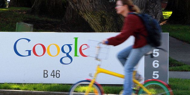 MOUNTAIN VIEW, CA - MARCH 10: A bicyclist rides by a sign at the Google headquarters March 10, 2010 in Mountain View, California. Google announced today that they are adding bicycle routes to their popular Google Maps and is available in 150 U.S. cities. (Photo by Justin Sullivan/Getty Images)