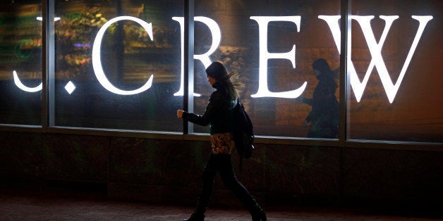 In this April 15, 2013 picture, a woman walks past a J. Crew retail store in Baltimore. Americans increased their spending in April at retail businesses, buying more cars and clothes after cutting purchases sharply in March. The rebound suggests consumers may help boost growth again in the April-June quarter(AP Photo/Patrick Semansky)