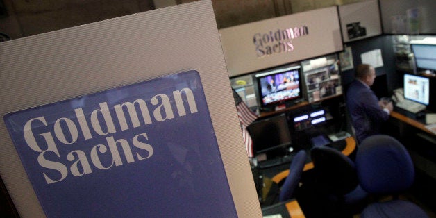 FILE - In this March 15, 2012 photo, a trader works in the Goldman Sachs booth on the floor of the New York Stock Exchange. Goldman Sachs more than doubled its first-quarter profits and announced plans to raise its dividend Tuesday, March 17, 2012. The strong results masked other problems, including a 16 percent decline in revenue. To make up for that, and to propel earnings higher, Goldman turned to cost-cutting. (AP Photo/Richard Drew)