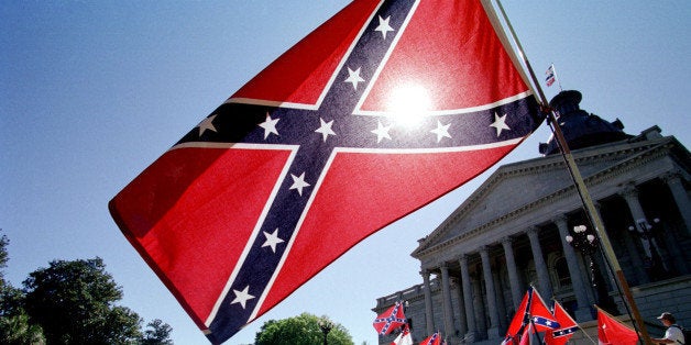 COLUMBIA, SC - APRIL 6: Confederate flag supporters demonstrate on the north steps of the capitol building 06 April, 2000 in Columbia, SC. The US southern state is split into two factions -- those for and those against the Confederate flag remaining above the capitol building. The 'Get in Step with the People of South Carolina' march, led by Charleston, SC, mayor Joe Riley, started in Charleston on 02 April, 2000 and proceeded approximately 120 miles to the captial of Columbia to protest the flag's placement above the capitol. (Photo credit should read ERIK PEREL/AFP/Getty Images)