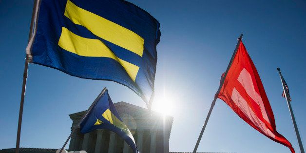 Equality flags fly in front of the Supreme Court in Washington, Tuesday, April 28, 2015. The Supreme Court is set to hear historic arguments in cases that could make same-sex marriage the law of the land. The justices are meeting Tuesday to offer the first public indication of where they stand in the dispute over whether states can continue defining marriage as the union of a man and a woman, or whether the Constitution gives gay and lesbian couples the right to marry. (AP Photo/Cliff Owen)