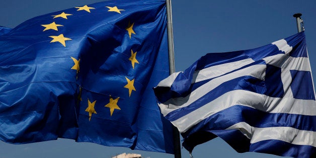 An EU and a Greek flag fly in front of the ancient Parthenon temple, in Athens, on Wednesday, April 9, 2014. Greece announced Wednesday it was returning to international bond markets for the first time in four years amid growing signs of confidence in the country at the forefront of the European debt crisis. (AP Photo/Petros Giannakouris)