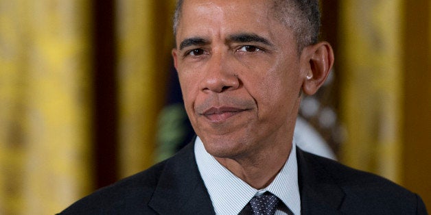 President Barack Obama pauses as he speaks before signing H.R. 2146 Defending Public Safety Employeesâ Retirement Act and H.R. 1295 Trade Preferences Extension Act of 2015, Monday, June 29, 2015, in the East Room of the White House in Washington. The president signed into law two hard-fought bills giving him greater authority to negotiate international trade deals and providing aid to workers whose jobs are displaced by such pacts. (AP Photo/Carolyn Kaster)