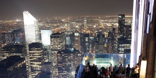 NEW YORK, NY - MAY 05: People congregate on the top of Rockefeller Center's viewing deck 'Top of the Rock' to view the Manhattan skyline on May 5, 2015 in New York City. In an effort to reduce Manhattan's carbon footprint, New York's City Council is considering a bill that would limit the amount of external light commercial buildings may use when empty at night. If approved, the bill could alter the use of lights in nearly 40,000 structures and potentially change the iconic nighttime view of Manhattan. The controversial bill has received support from Mayor Bill de Blasio. (Photo by Spencer Platt/Getty Images)