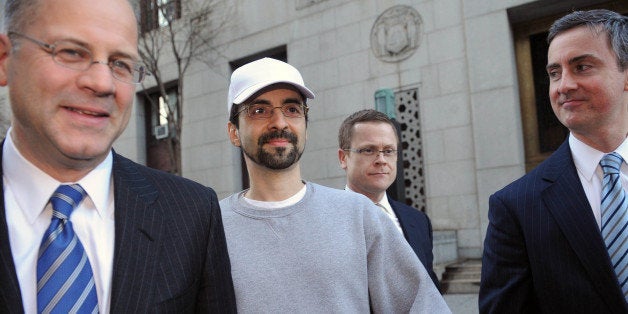 Sergey Aleynikov, center, exits Manhattan federal court Friday, Feb. 17, 2012, in New York, The unusually speedy mandate from the 2nd U.S. Circuit Court of Appeals in Manhattan will result in freedom for Aleynikov, who was sentenced in March to more than eight years in prison. He was convicted in December 2010 of stealing trade secrets and transporting stolen property in interstate and foreign commerce. (AP Photo/Louis Lanzano)