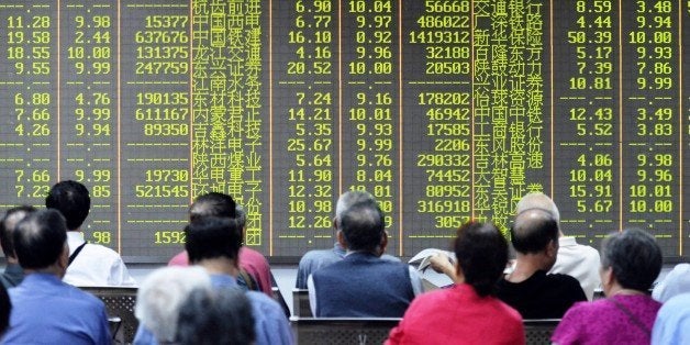 Investors sit in front of a screen showing market movements in a stock firm in Hangzhou, eastern China's Zhejiang province on July 8, 2015. China's benchmark Shanghai stock index was down more than 4.5 percent by mid-morning as additional government moves failed to shore up the tumbling market and contagion began to spread elsewhere. AFP PHOTO CHINA OUT (Photo credit should read STR/AFP/Getty Images)