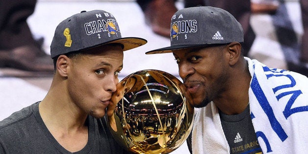 CLEVELAND, OH - JUNE 16: Stephen Curry #30 and Andre Iguodala #9 of the Golden State Warriors celebrate with the Larry O'Bri