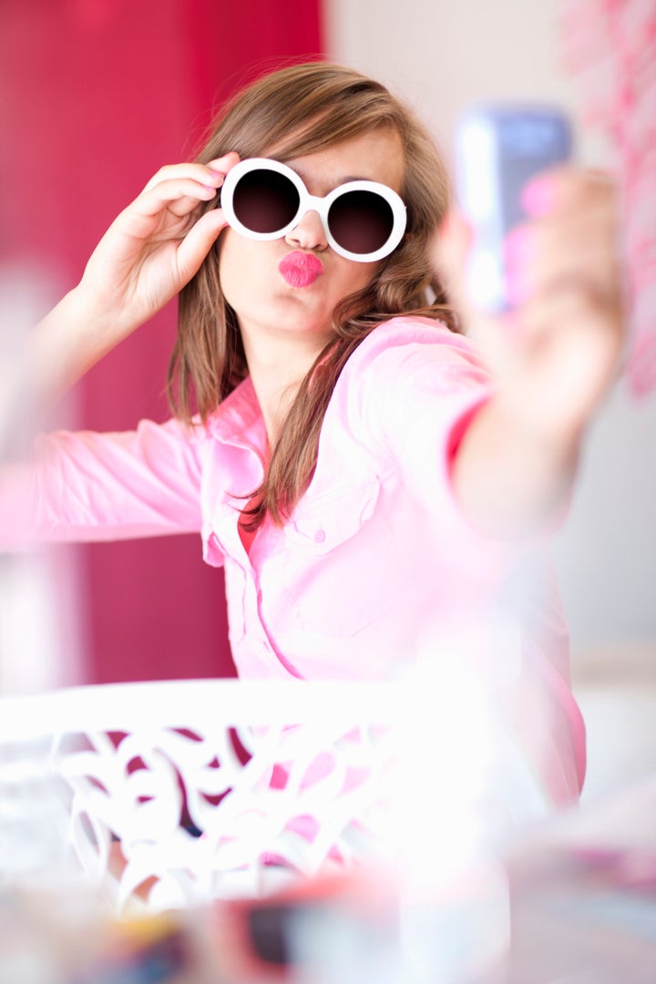 Teenage girl taking picture of herself