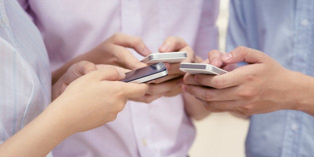 Close-up of hands using smartphones