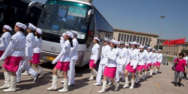 In this May 29, 2014 photo, high school students dressed in uniforms march on Tiananmen Square to stand at guard posts of Young Pioneers, a youth group under the Communist Party of China, around the Monument to the People's Heroes on Tiananmen Square in Beijing. Elite members of youth Communist groups in schools are organized to guard the posts as a nationalistic and party loyalty education. A quarter century after the Communist Partyâs attack on demonstrations centered on Tiananmen Square on June 4, 1989, it is little more than a distant tale to young Chinese. The ruling party prohibits public discussion and 1989 is banned from textbooks and Chinese websites. (AP Photo/Alexander F. Yuan)