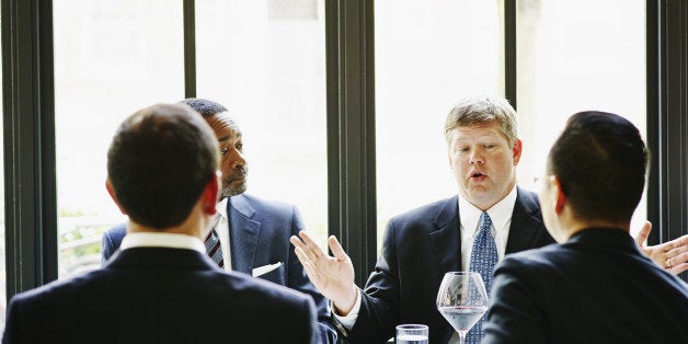 Business executive leading discussion during business meeting in restaurant