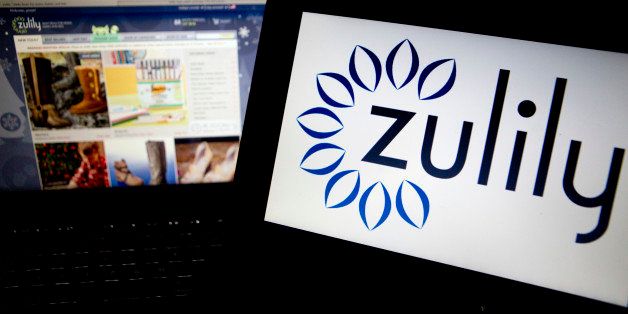 The Zulily Inc. website and logo are displayed on laptop computers arranged for a photograph in Washington, D.C., U.S., on Friday, Nov. 15, 2013. Zulily Inc., which runs a shopping website targeted at moms, jumped 71 percent after raising $253 million in its U.S. initial public offering, pricing the shares above an increased range. Photographer: Andrew Harrer/Bloomberg via Getty Images