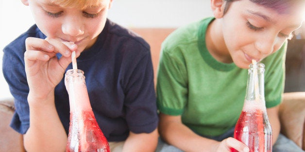 Boys drinking soda together