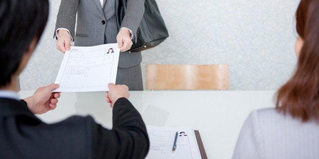 Young Woman Handing Over Her Resume