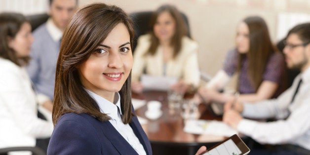 Successful businesswoman at the office leading a group