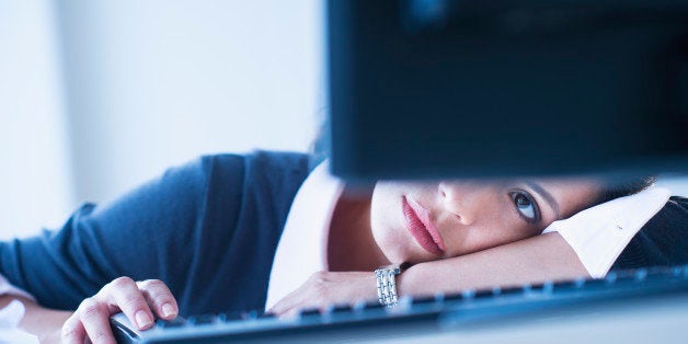 USA, New Jersey, Jersey City, Businesswoman looking tired in front of computer