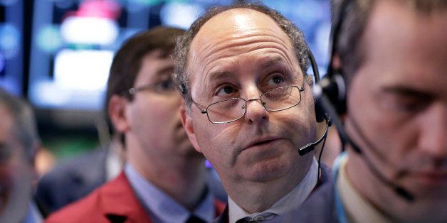 Trader Gordon Charlop, center, works on the floor of the New York Stock Exchange, Wednesday, April 1, 2015. U.S. stocks moved lower in afternoon trading Wednesday, as discouraging economic reports on manufacturing, jobs and construction spending stoked concerns about corporate profits and global growth. (AP Photo/Richard Drew)