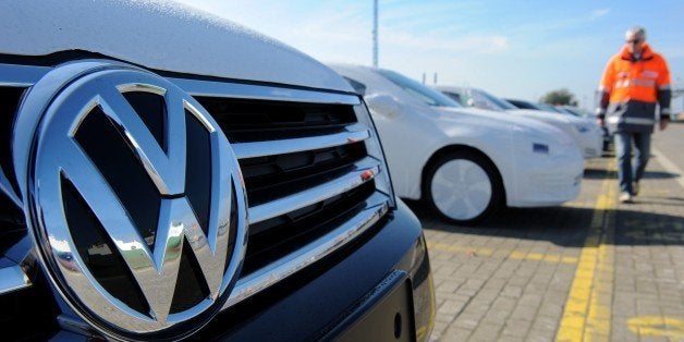 A new Volkswagen (VW) car is seen in the foreground as new cars of the Volkswagen group are parked ready for shipping at the car terminal of the port of Bremerhaven, northwestern Germany, on October 2, 2015. New car registrations in Germany, a key measure of demand in one of the most important sectors of Europe's top economy, rose in September, data showed, amid fears the Volkswagen pollution-cheating scandal could weigh on sales in the sector. AFP PHOTO / DPA / INGO WAGNER +++ GERMANY OUT +++ (Photo credit should read INGO WAGNER/AFP/Getty Images)