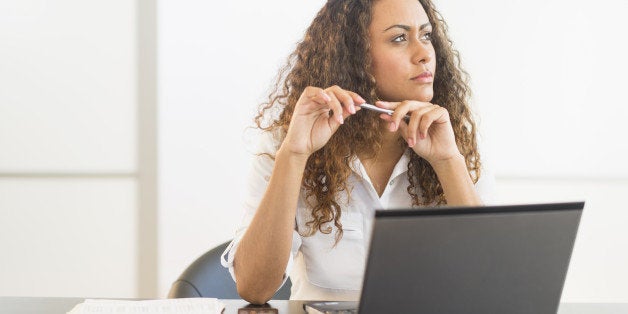 USA, New Jersey, Jersey City, Office worker sitting by desk with laptop