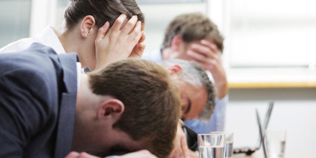 Business people sleeping in the conference room during a meeting