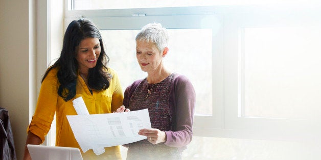 Business women discussing plans together.