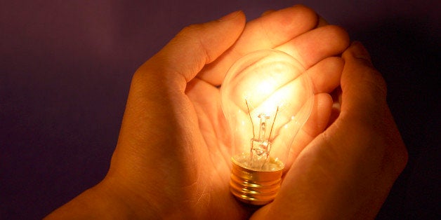 Hands holding lightbulb