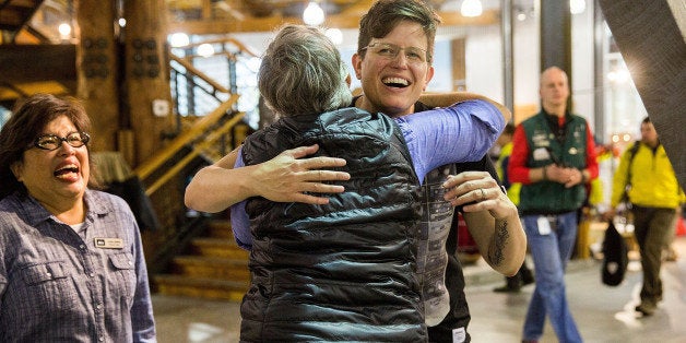 SEATTLE, WA - OCTOBER 27: Employees of Specialty Outdoor Retailer REI react to news of Black Friday closure at 143 stores nationwide with Rachel Ligtenberg on October 27, 2015 in Seattle, Washington. (Photo by Suzi Pratt/Getty Images for REI)