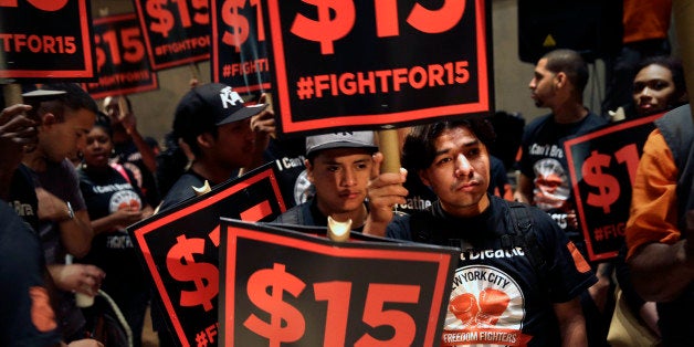 Demonstrators rally for a $15 minimum wage before a meeting of the wage board in New York, Monday, June 15, 2015. The board, created by Gov. Andrew Cuomo, will consider a minimum wage increase for New York's fast-food workers. (AP Photo/Seth Wenig)