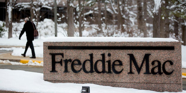 A man walks into the Freddie Mac headquarters in McLean, Virginia, U.S., on Tuesday, March 18, 2014. Freddie Mac and Fannie Mae would continue paying all of their profits to the Treasury for the next five years under bipartisan Senate legislation designed to wind down the U.S.-owned mortgage financiers and overhaul the government's role in the housing market. Photographer: Andrew Harrer/Bloomberg via Getty Images