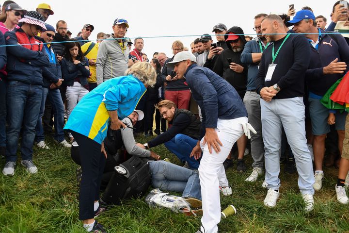 US golfer Brooks Koepka (right) rushed to the injured spectator 